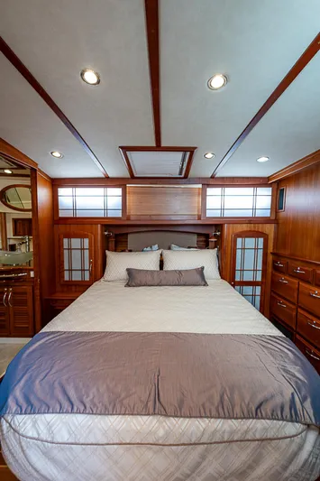Captain And The Kid Yacht Photos Pics Luxurious bedroom interior of 2012 Sabre 48 Salon Express yacht with elegant wood finishes.