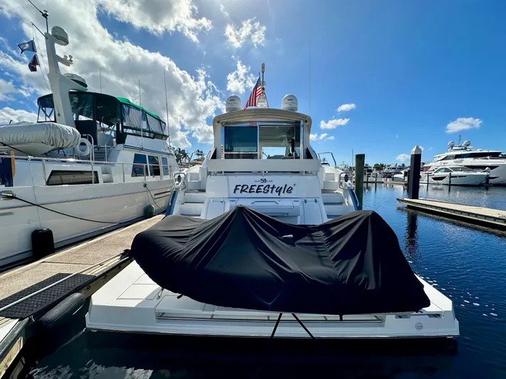  Yacht Photos Pics 2020 Cruisers Yachts 50 Cantius docked at marina under clear blue sky.