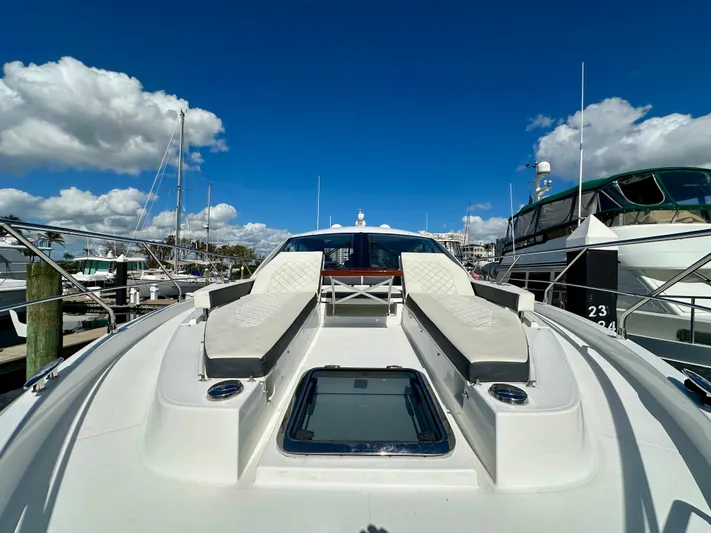  Yacht Photos Pics 2020 Cruisers Yachts 50 Cantius with sun loungers, docked under blue sky.