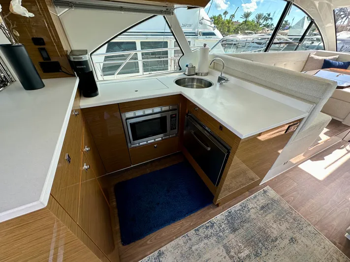  Yacht Photos Pics Modern kitchen in 2020 Cruisers Yachts 50 Cantius with sleek appliances and wood cabinetry.