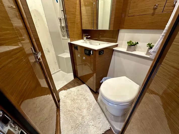 Yacht Photos Pics Luxurious bathroom in 2020 Cruisers Yachts 50 Cantius, featuring modern fixtures and elegant wood finishes.