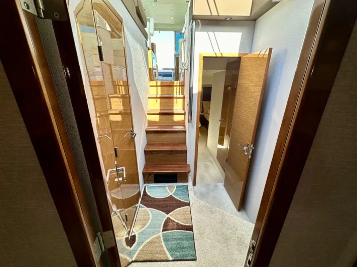  Yacht Photos Pics Interior of 2020 Cruisers Yachts 50 Cantius with modern wood finishes and carpeted flooring.