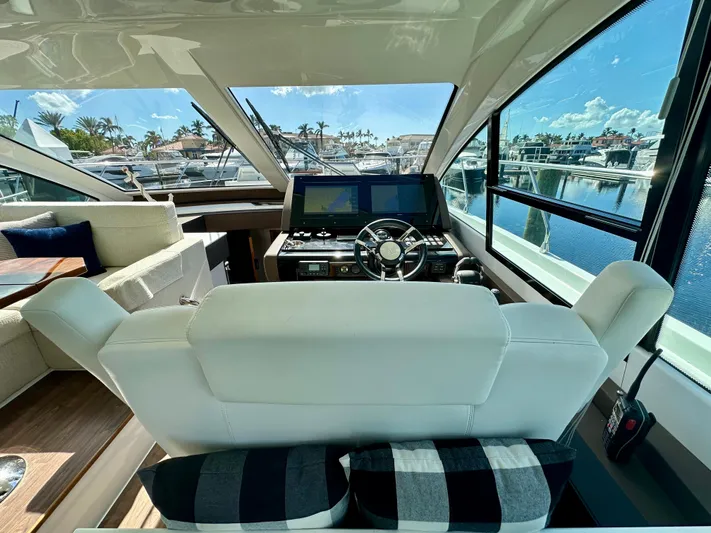  Yacht Photos Pics Interior view of 2020 Cruisers Yachts 50 Cantius helm with luxurious seating and modern controls.