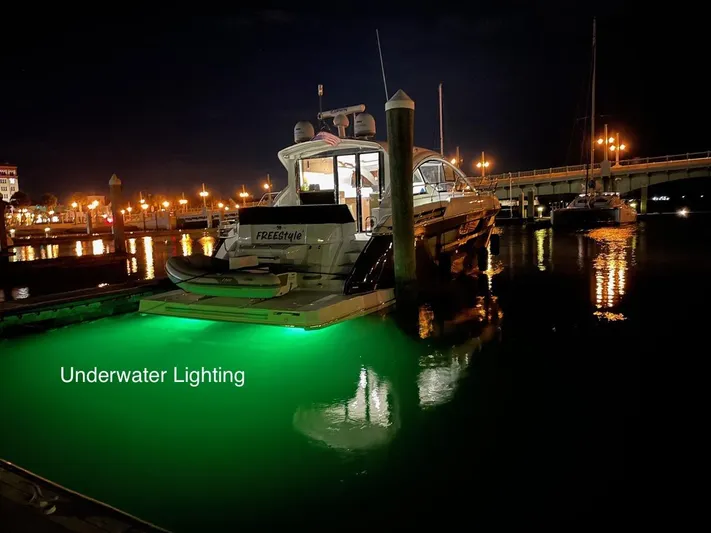  Yacht Photos Pics 2020 Cruisers Yachts 50 Cantius with green underwater lighting at night in a marina.