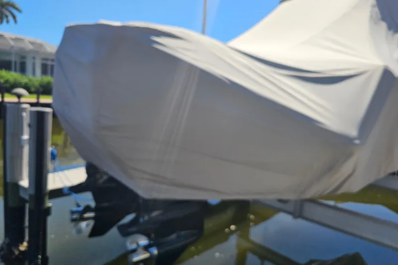  Yacht Photos Pics Covered 2018 Tidewater 320 CC Adventure boat docked near water.