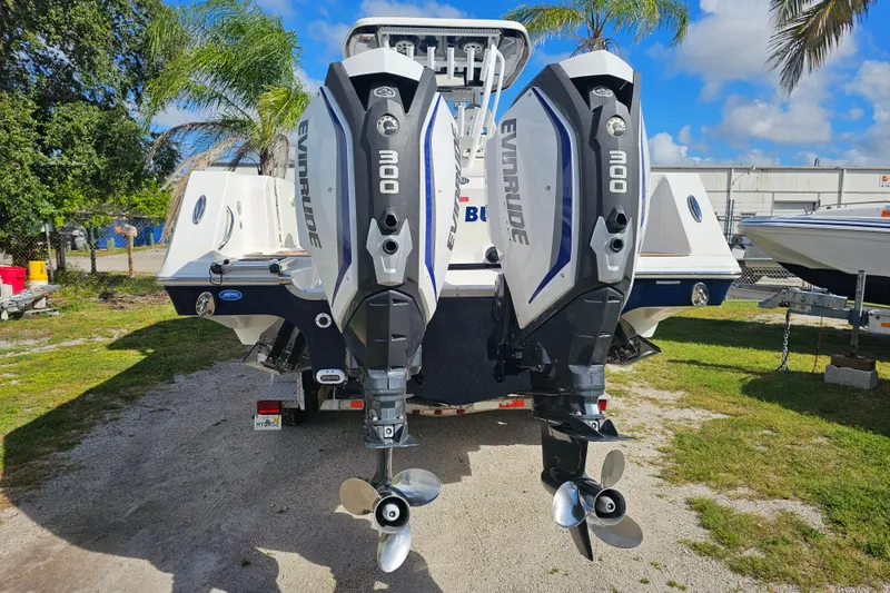  Yacht Photos Pics 2018 Tidewater 320 CC Adventure boat with dual Evinrude 300 engines, parked outdoors.