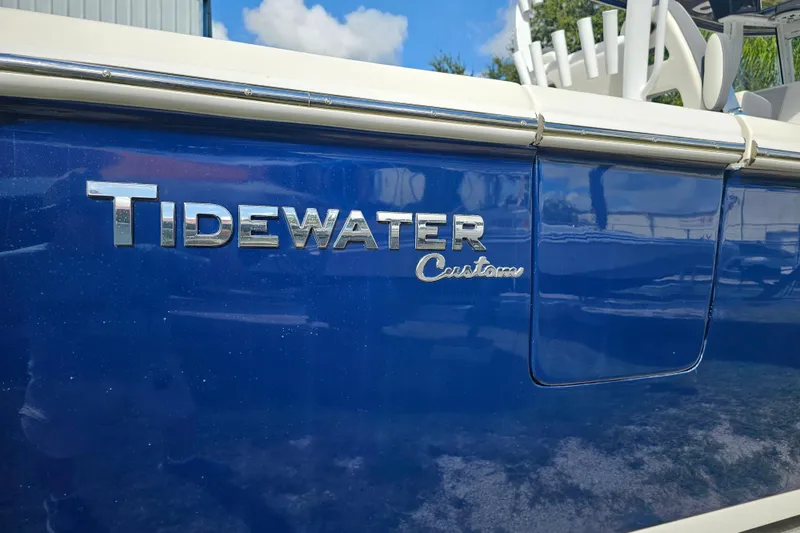  Yacht Photos Pics Blue 2018 Tidewater 320 CC Adventure boat with custom lettering.