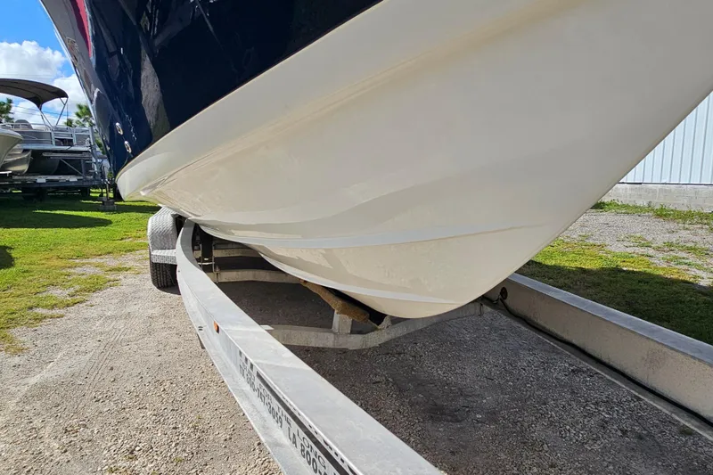  Yacht Photos Pics 2018 Tidewater 320 CC Adventure boat on trailer, showcasing sleek hull design.