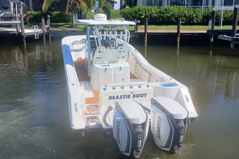  Yacht Photos Pics 2018 Tidewater 320 CC Adventure boat with dual Evinrude engines docked in a marina.