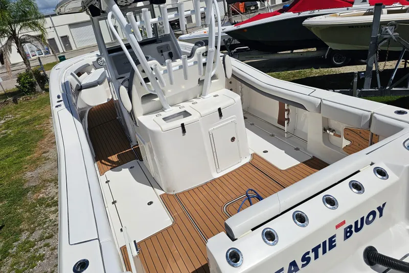  Yacht Photos Pics 2018 Tidewater 320 CC Adventure boat with spacious deck and seating, docked outdoors.