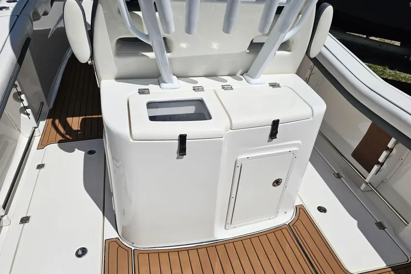  Yacht Photos Pics 2018 Tidewater 320 CC Adventure boat interior with rod holders and storage compartments.