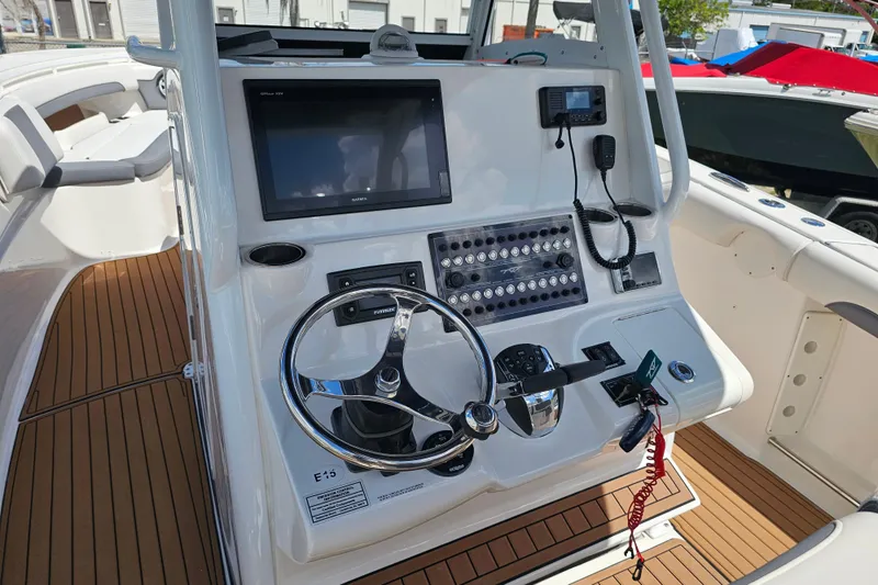  Yacht Photos Pics 2018 Tidewater 320 CC Adventure boat helm with modern controls and navigation system.