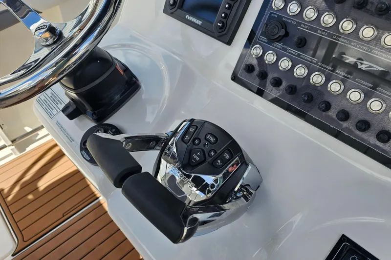 Yacht Photos Pics Control panel of 2018 Tidewater 320 CC Adventure boat with steering wheel and throttle.