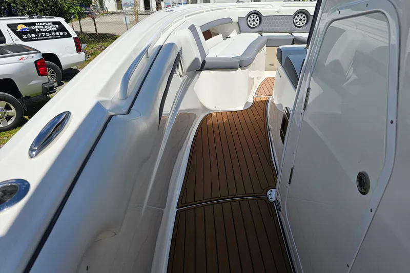  Yacht Photos Pics 2018 Tidewater 320 CC Adventure boat interior with teak flooring and cushioned seating.