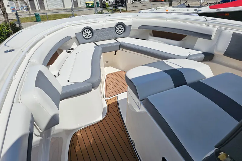  Yacht Photos Pics 2018 Tidewater 320 CC Adventure boat interior with cushioned seating and teak flooring.