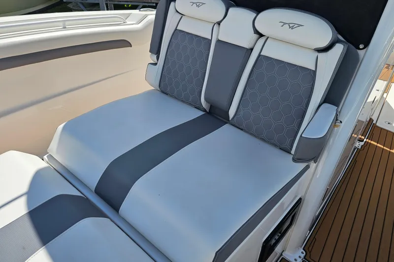  Yacht Photos Pics 2018 Tidewater 320 CC Adventure boat seating with gray and white upholstery.