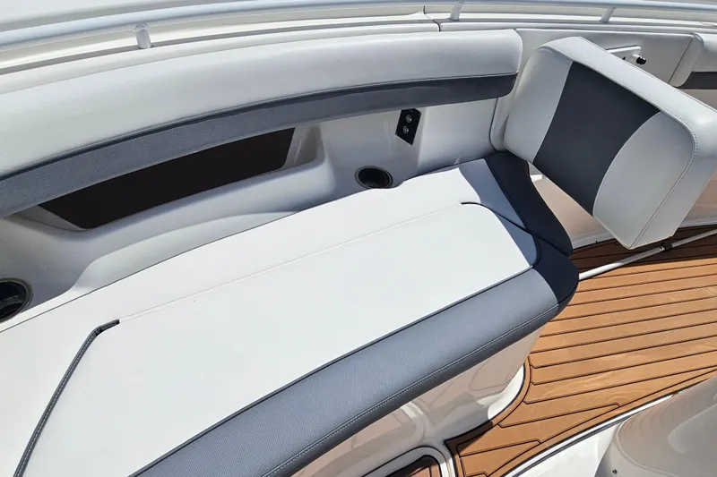 Yacht Photos Pics 2018 Tidewater 320 CC Adventure boat interior with cushioned seating and wood-style flooring.