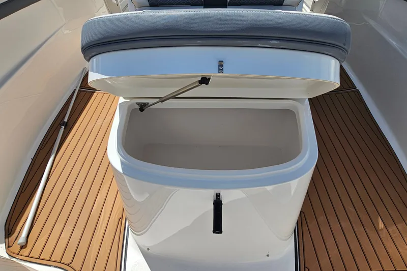  Yacht Photos Pics Open storage compartment on 2018 Tidewater 320 CC Adventure boat with wooden deck.