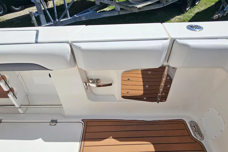  Yacht Photos Pics 2018 Tidewater 320 CC Adventure boat interior with teak flooring and cushioned seating.