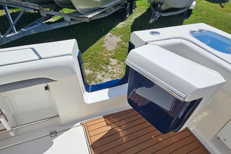  Yacht Photos Pics 2018 Tidewater 320 CC Adventure boat interior with teak flooring and storage compartments.