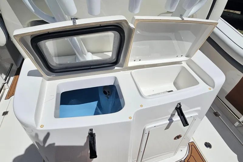  Yacht Photos Pics 2018 Tidewater 320 CC Adventure boat storage compartments with open lids.