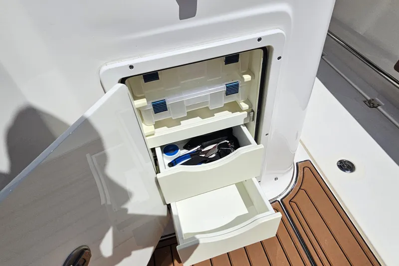  Yacht Photos Pics Open storage compartment on 2018 Tidewater 320 CC Adventure boat with drawers and accessories.