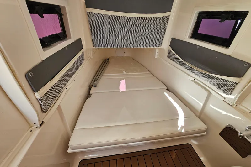  Yacht Photos Pics 2018 Tidewater 320 CC Adventure cabin interior with cushioned seating and storage.
