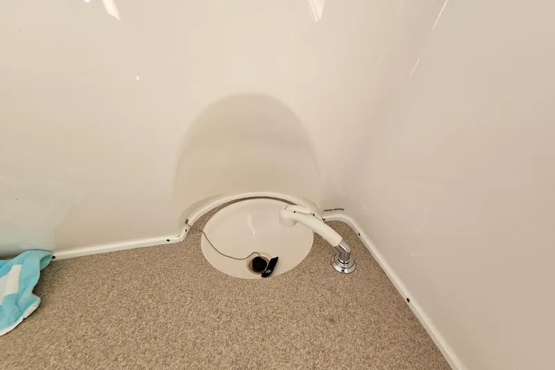  Yacht Photos Pics 2018 Tidewater 320 CC Adventure boat interior with plumbing fixture and carpeted floor.