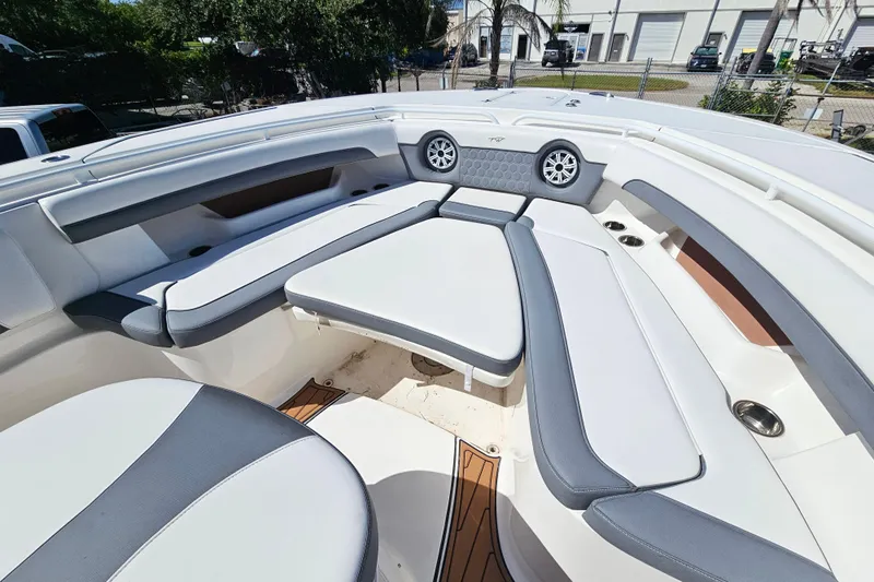  Yacht Photos Pics 2018 Tidewater 320 CC Adventure boat interior with cushioned seating and speakers.