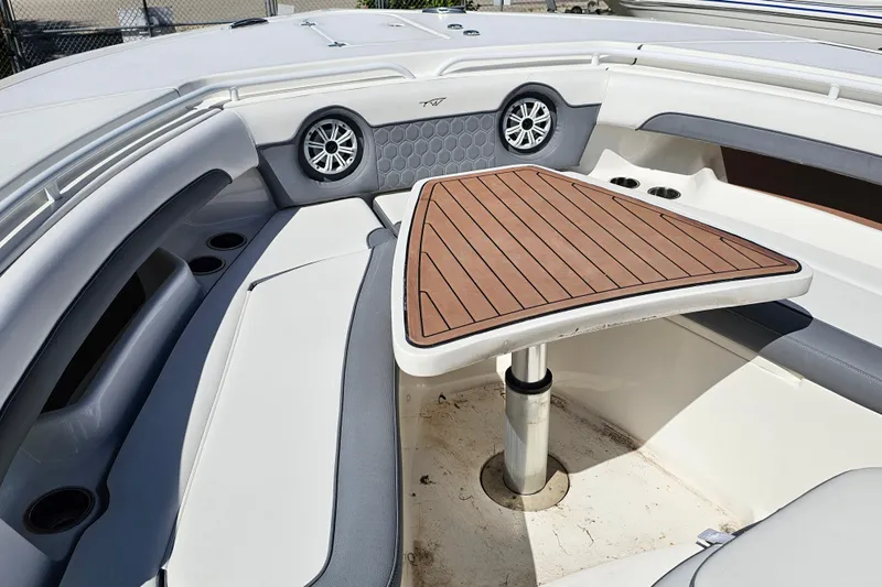  Yacht Photos Pics 2018 Tidewater 320 CC Adventure boat interior with seating and wooden table.