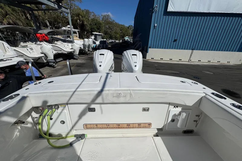  Yacht Photos Pics 2023 Regulator 31 boat with dual engines, docked near other vessels.