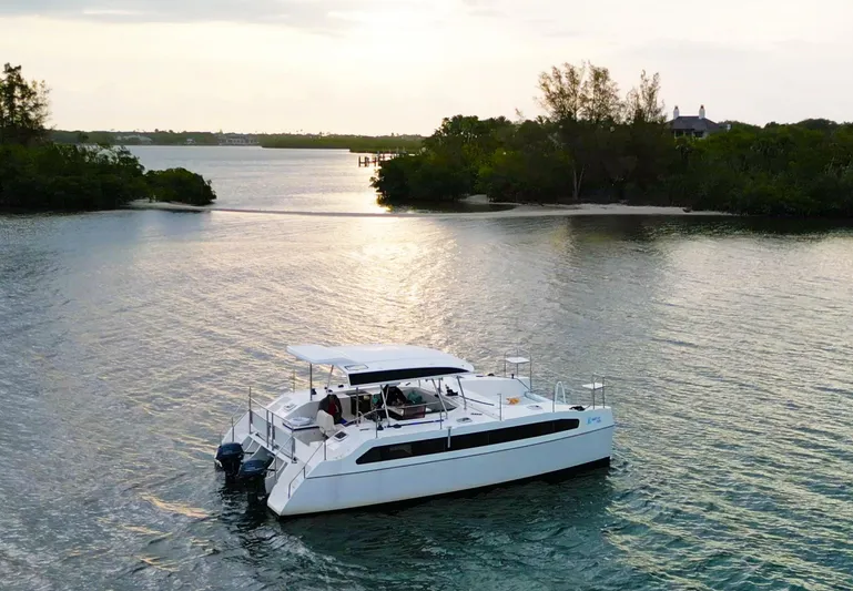  Yacht Photos Pics Modern Smart Cat M280 Power boat cruising on serene waters at sunset, 2025 model.