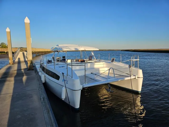  Yacht Photos Pics Modern 2025 Smart Cat M280 Power catamaran docked at a serene waterfront.