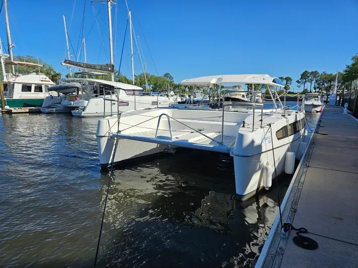  Yacht Photos Pics 2025 Smart Cat M280 Power catamaran docked at a marina under clear blue skies.