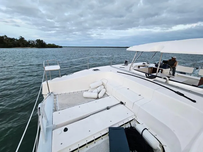  Yacht Photos Pics 2025 Smart Cat M280 Power boat on calm waters under cloudy sky.