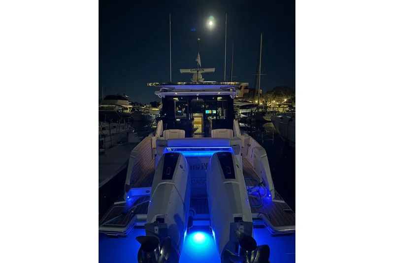  Yacht Photos Pics 2025 Tiara Yachts 43 LE illuminated at night in a marina setting.