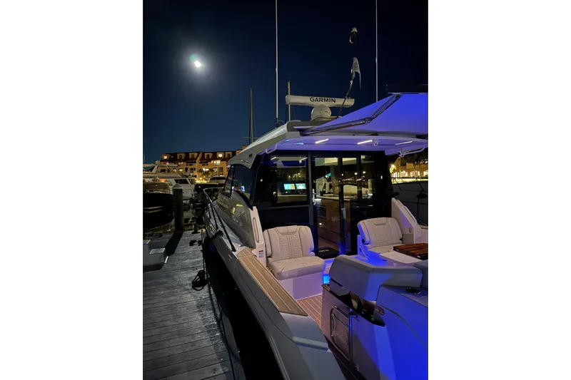  Yacht Photos Pics 2025 Tiara Yachts 43 LE docked at night, illuminated under moonlight.