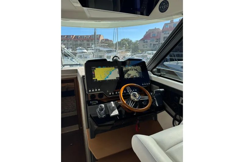  Yacht Photos Pics Helm of 2025 Tiara Yachts 43 LE with navigation screens and wooden steering wheel.