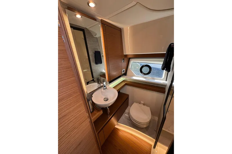  Yacht Photos Pics Luxurious bathroom in 2025 Tiara Yachts 43 LE, featuring modern fixtures and elegant wood finishes.