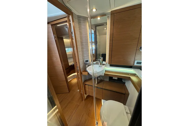  Yacht Photos Pics Luxurious bathroom interior of 2025 Tiara Yachts 43 LE, featuring modern wood finishes.