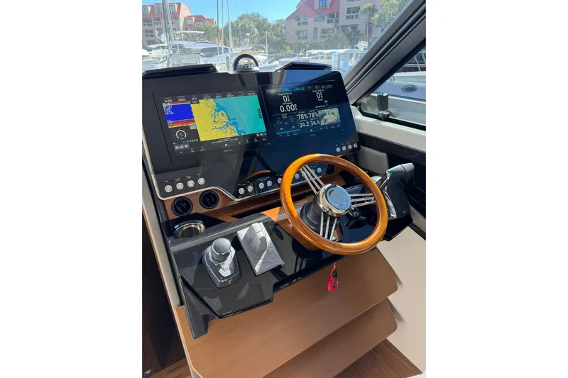  Yacht Photos Pics 2025 Tiara Yachts 43 LE helm with dual displays and wooden steering wheel.