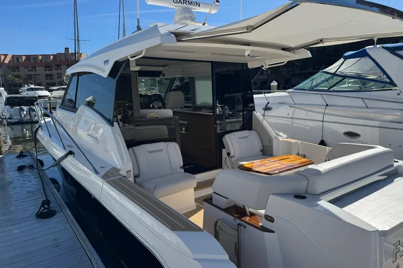  Yacht Photos Pics 2025 Tiara Yachts 43 LE luxury yacht docked, featuring elegant seating and modern design.