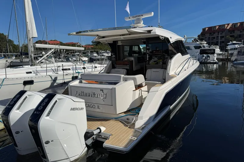  Yacht Photos Pics 2025 Tiara Yachts 43 LE docked, featuring dual Mercury engines, in a marina setting.