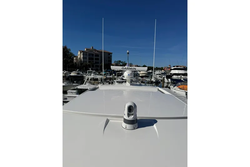  Yacht Photos Pics 2025 Tiara Yachts 43 LE with Garmin equipment, docked in a marina under clear blue skies.