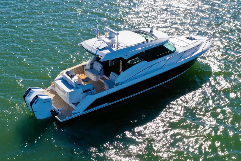  Yacht Photos Pics 2025 Tiara Yachts 43 LE cruising on sparkling water, showcasing sleek design and powerful engines.