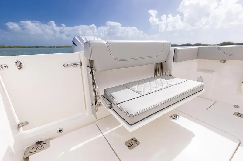  Yacht Photos Pics Manufacturer Provided Image: 2025 Pursuit S 248 Sport boat with foldable seating, white upholstery, and ocean backdrop.