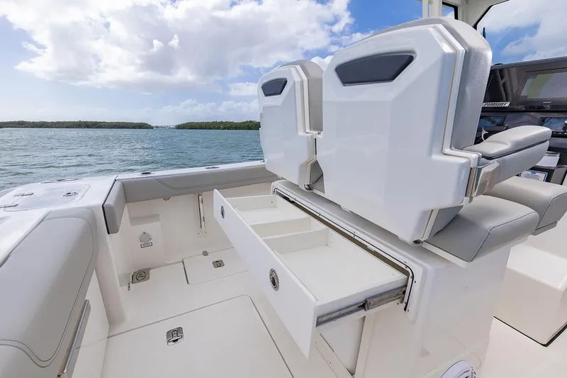  Yacht Photos Pics Manufacturer Provided Image: 2025 Pursuit S 248 Sport boat interior with open storage drawer, ocean view.