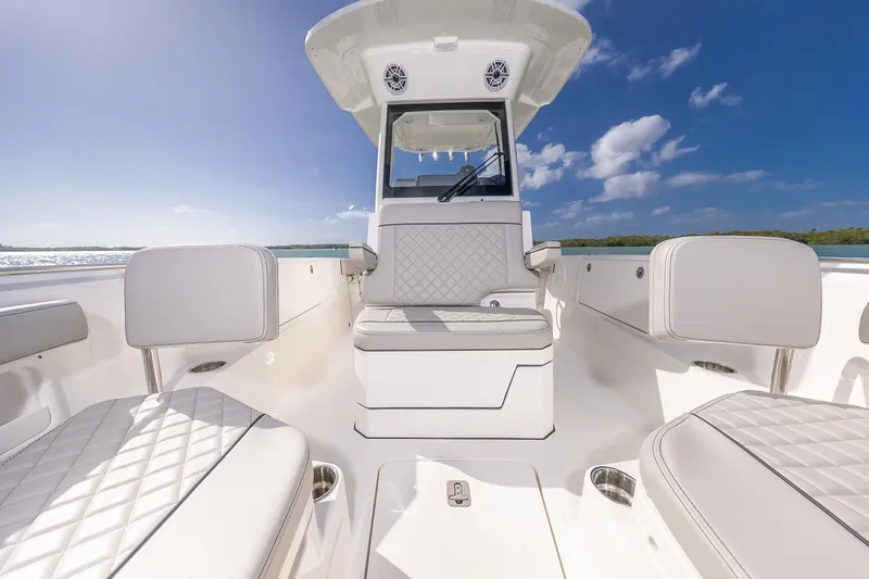  Yacht Photos Pics Manufacturer Provided Image: 2025 Pursuit S 248 Sport boat interior with white seating, under a clear blue sky.