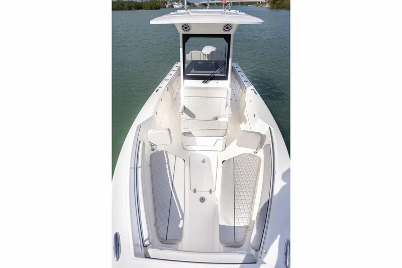  Yacht Photos Pics Manufacturer Provided Image: 2025 Pursuit S 248 Sport boat interior with seating and helm, on calm water.