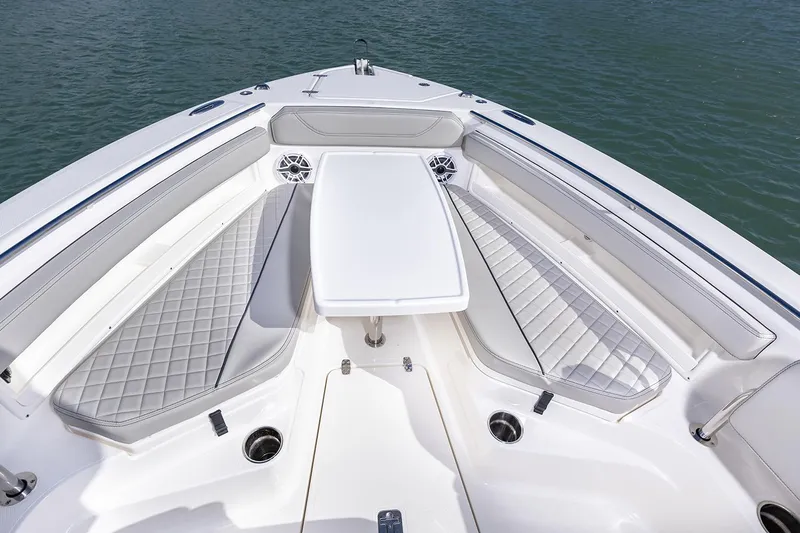  Yacht Photos Pics Manufacturer Provided Image: 2025 Pursuit S 248 Sport boat interior with cushioned seating and table on water.